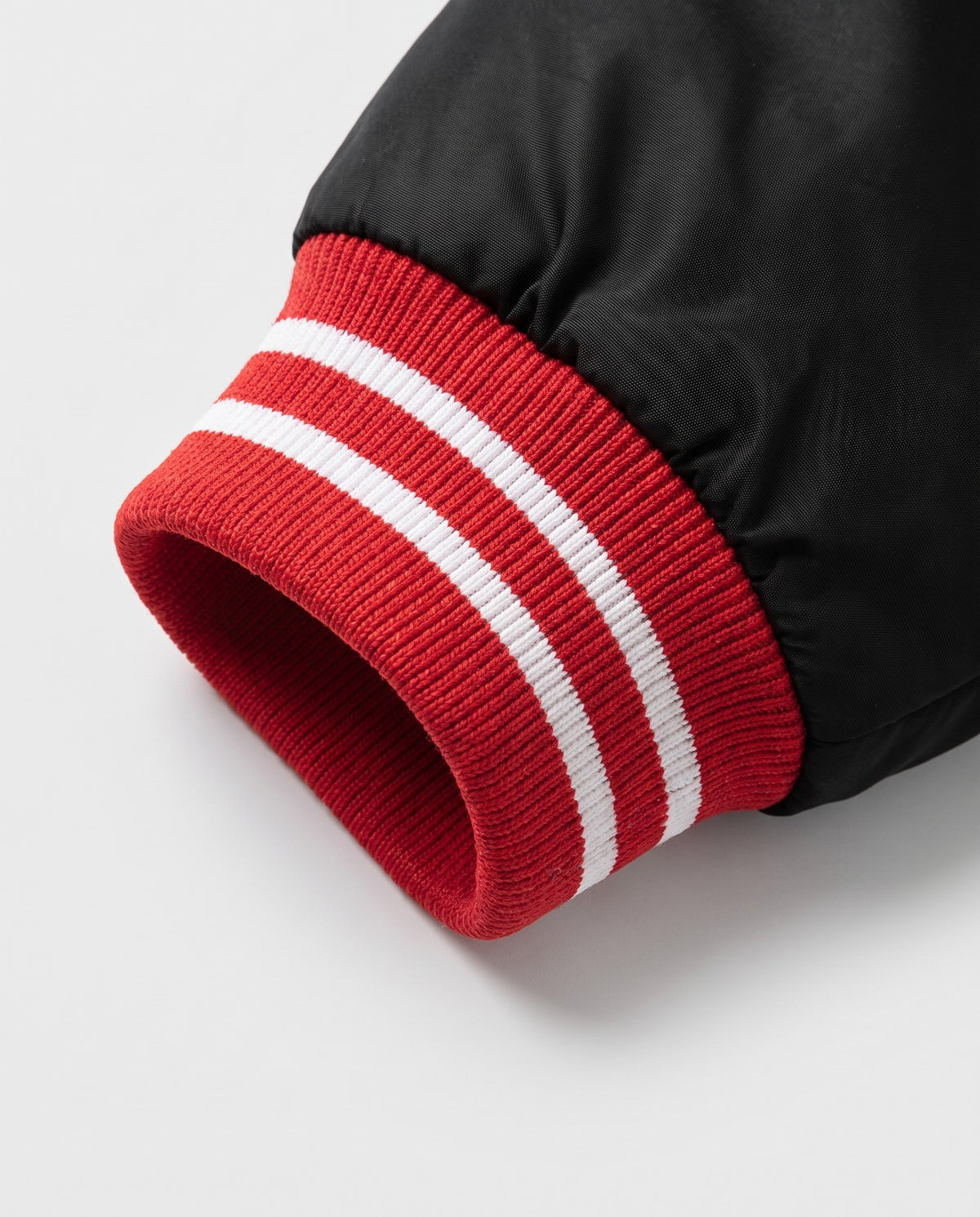 Détail du poignet rayé du blouson baseball homme